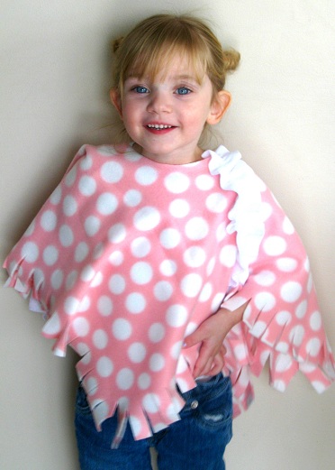 little girl wearing pink polka dot fleece poncho