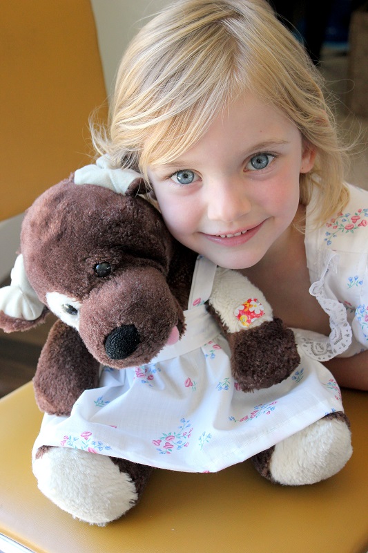 little girl and stuffed dog