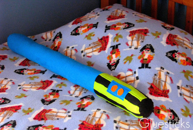 light saber pillow on bed