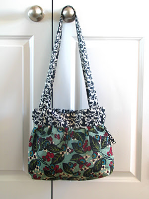 green and black floral fabric handbag