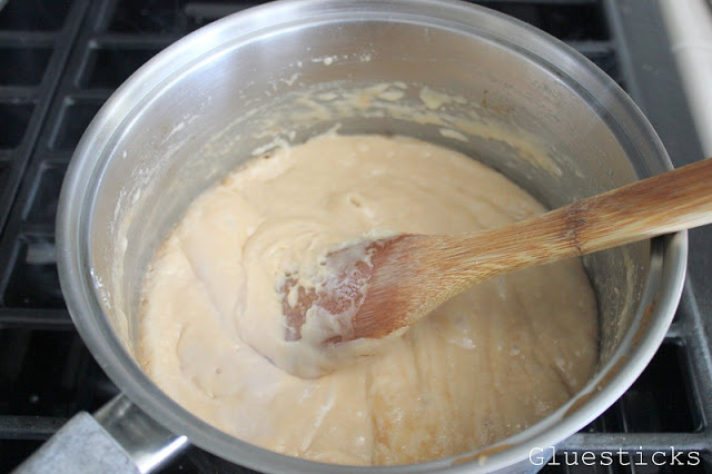 sauce pan with wooden spoon and toffee ingredients bubbling and brown