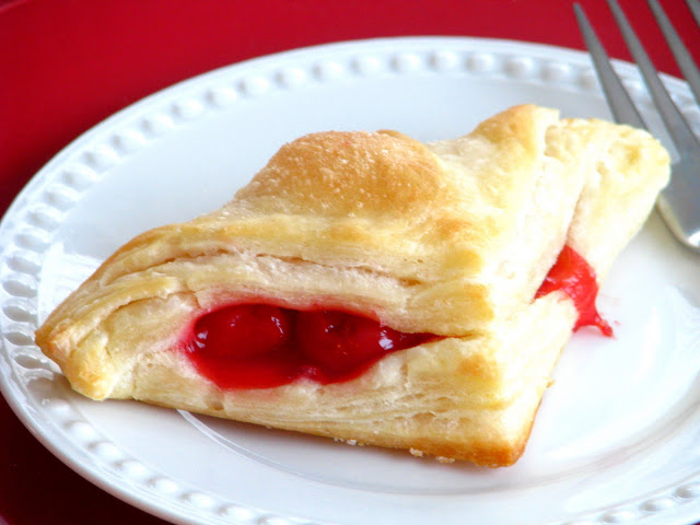 cherry turnover on white place with fork
