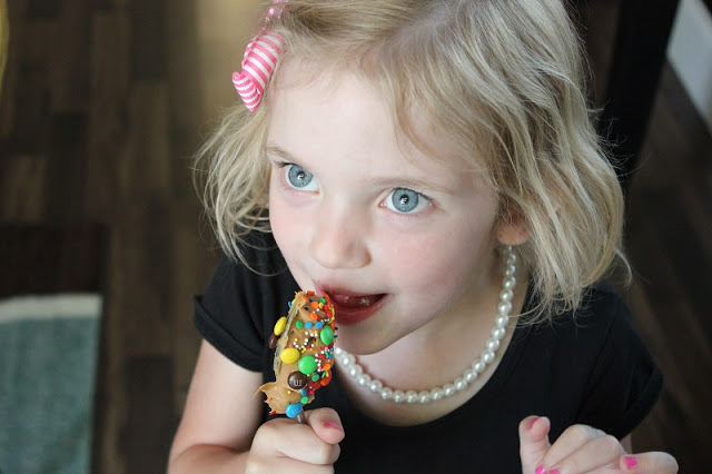 toddler licking peanut butter spoon