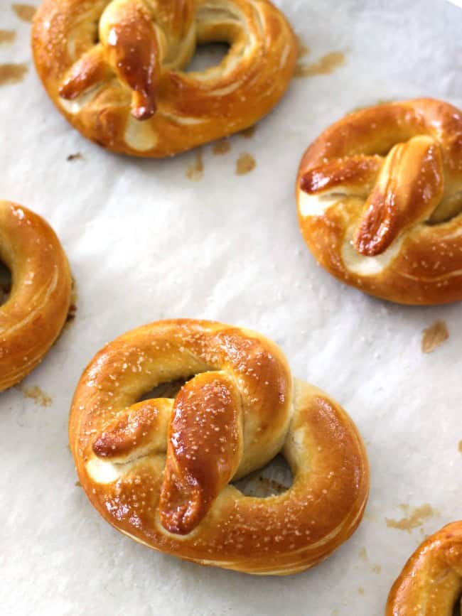 Auntie Anne's copycat no boil soft baked pretzels are so delicious and easy to make. Make pretzel shapes or pretzel bites in a variety of flavors! pretzels on baking sheet