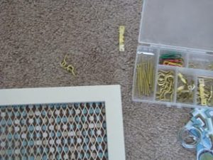 box of hardware to hang up framed jewelry holder