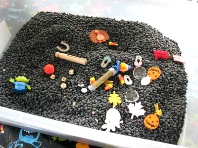 black beans and small toys inside tote