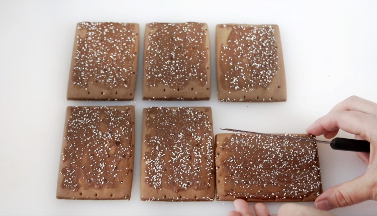 6 pop tarts being cut into gingerbread house shapes