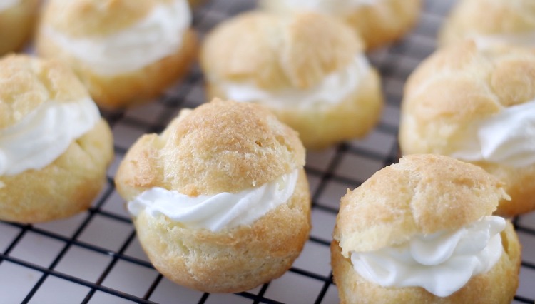 filled cream puffs on cooling rack