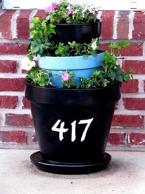 tiered terracotta planter with house numbers painted on front