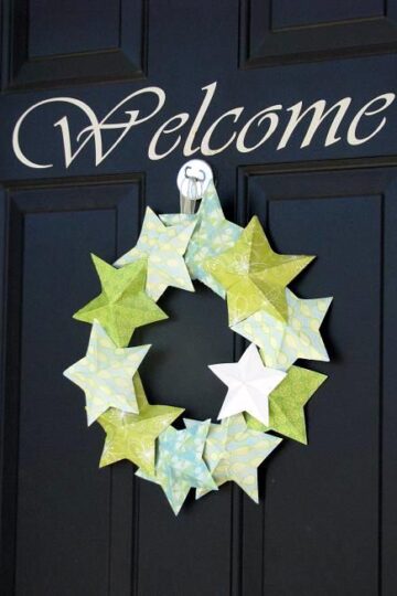 paper star wreath hanging on black door