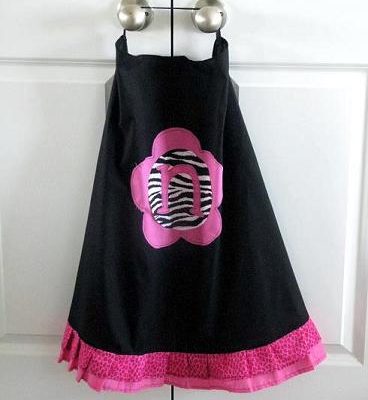 black cape with pink ruffle