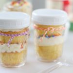 2 jars with cupcakes inside and white lids