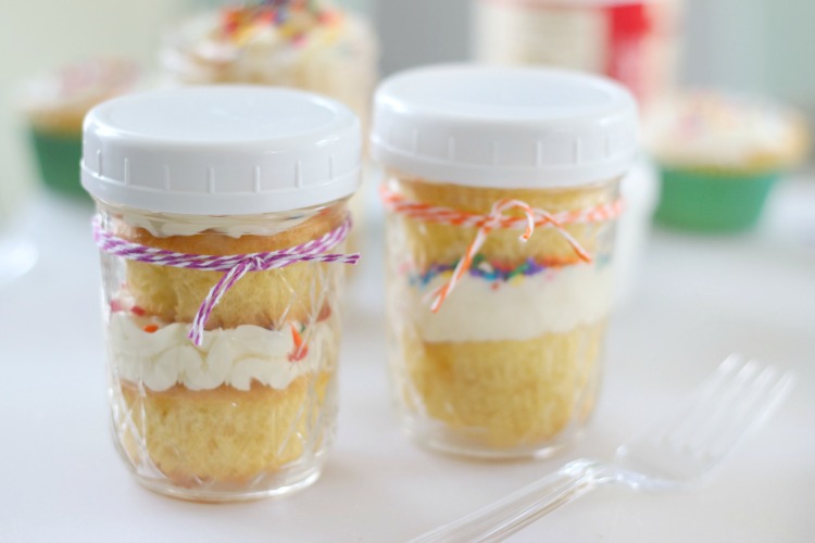2 jars with cupcakes inside and white lids