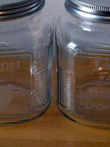 two jars with acid etched designs on front