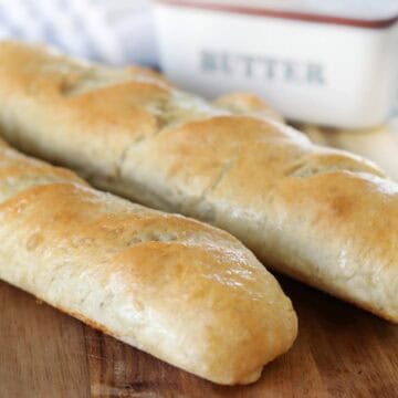 2 loaves of bread on cutting board