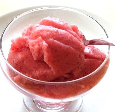 glass ice cream bowl with strawberry slush and spoon
