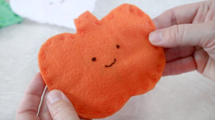 eyes and mouth stitched on front of pumpkin