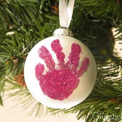 silver ornament with pink glitter handprint