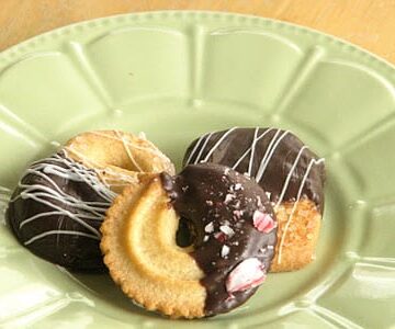 green plate with danish cookies