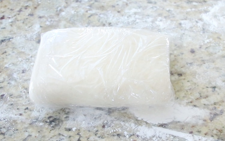 puff pastry dough wrapped in plastic wrap