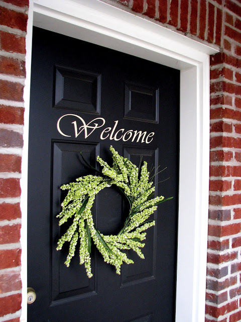 front door with welcome sign and wreath
