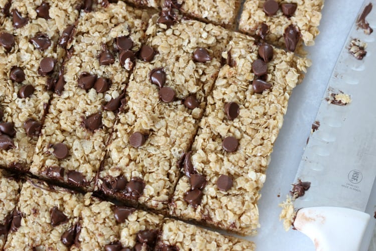 baking sheet with finished cut granola bars and knife