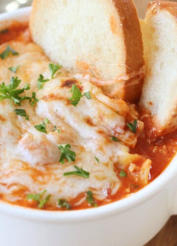 bowl of lasagna soup with cheese broiled on top