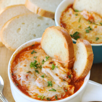 bowl of lasagna soup with baguette slices