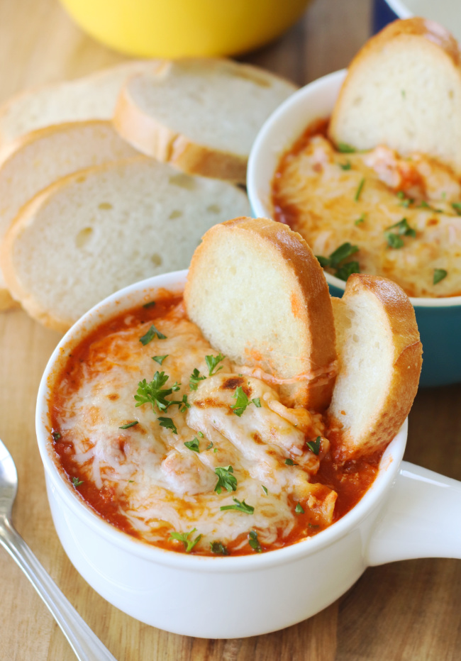 bowl of lasagna soup with baguette slices