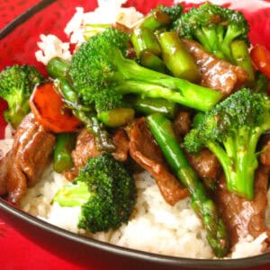 Beef and broccoli stir fry served over white rice.