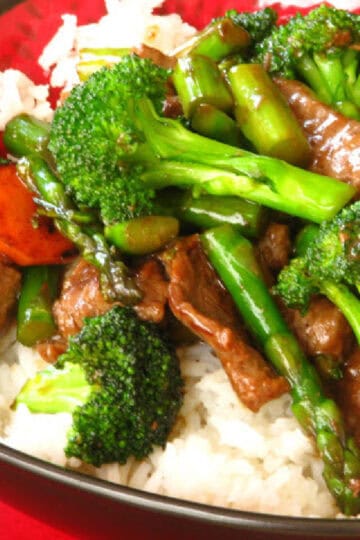 Beef and broccoli stir fry served over white rice.
