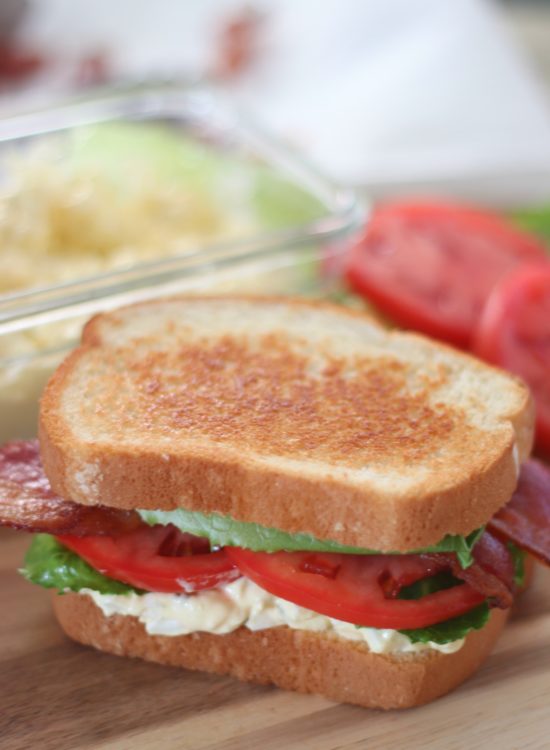 egg salad blt sandwich on cutting board