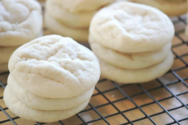 soft sugar cookies stacked on baking rack