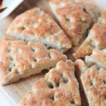 slices of parmesan focaccia bread on cutting board