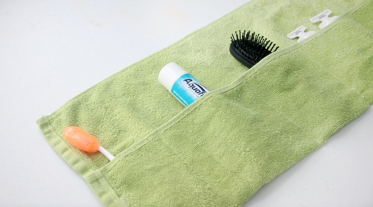unrolled hand towel caddy with tooth brush and toothpaste with brush and shampoo