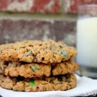 3 monster cookies stacked on napkin