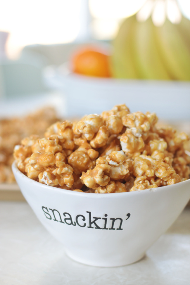 small bowl of baked caramel corn on kitchen table