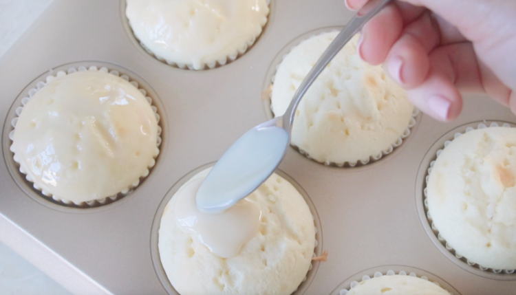 baked cupcakes in pan spread with sweetened condensed milk