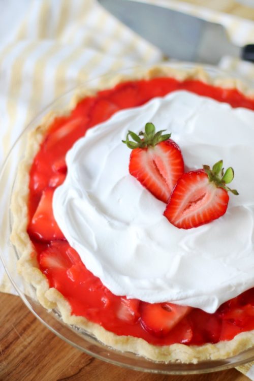 strawberry pie close up shot with strawberries as a garnish