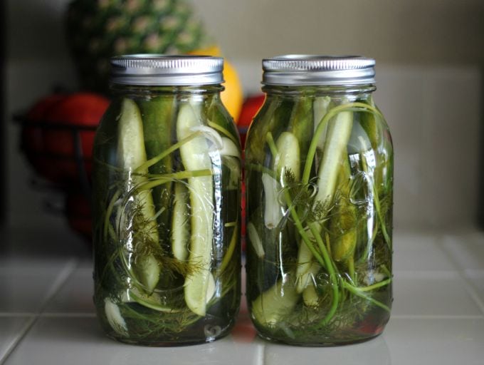 two jars of pickles 24 hours old on counter