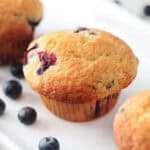 Blueberry muffins on white platter.