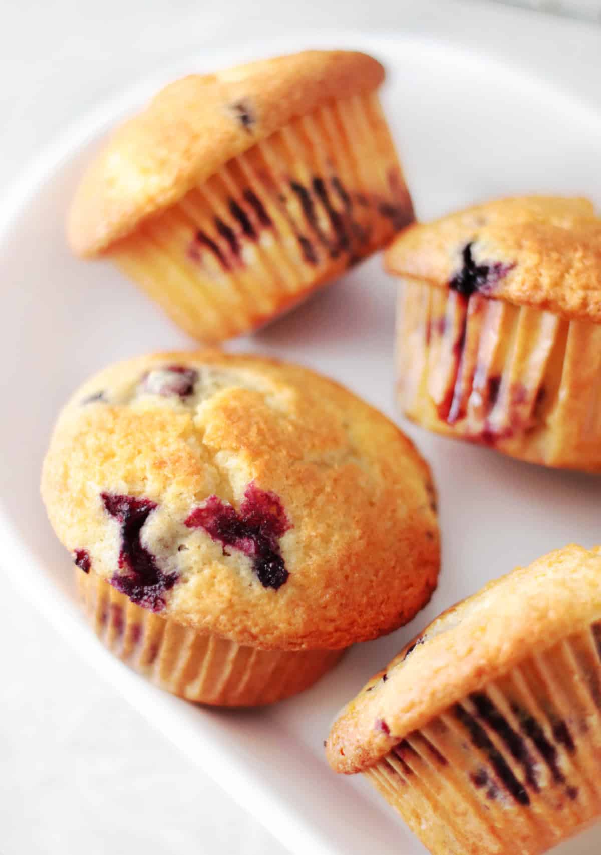 4 blueberry muffins on platter.