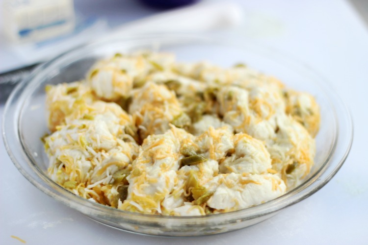 glass pie pan with jalapeño cheese bread, ready to rise and bake