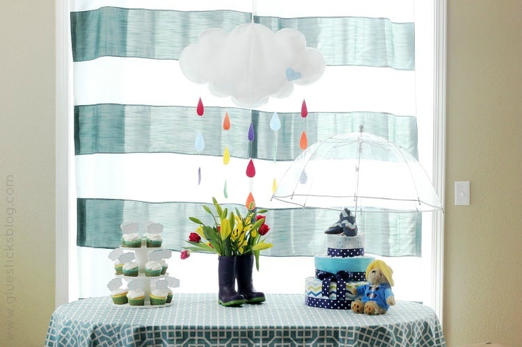 An April Showers diaper cake for a springtime baby shower. Complete with diapers, shoes, and receiving blankets.