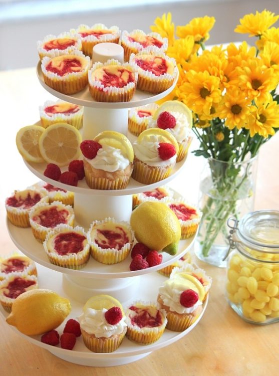 dessert stand with lemon cupcakes and mini raspberry cheesecakes