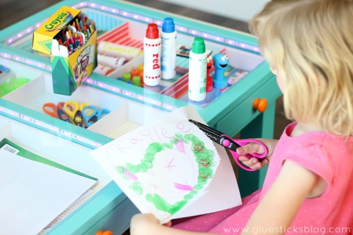 little girl creating a project at desk