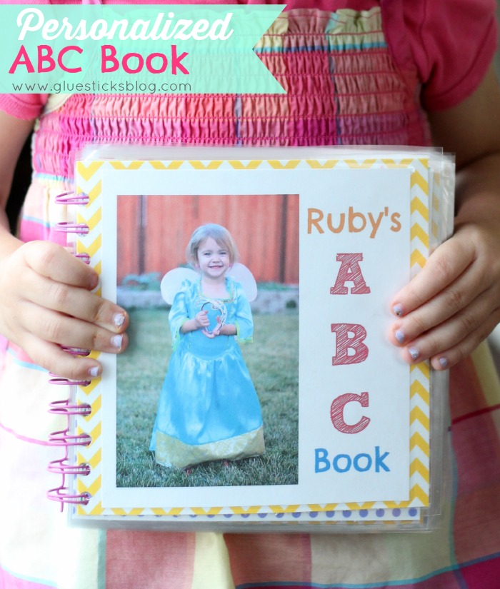 child holding personalized alphabet book