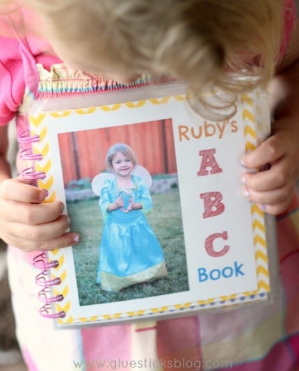 little girl holding personalized abc book