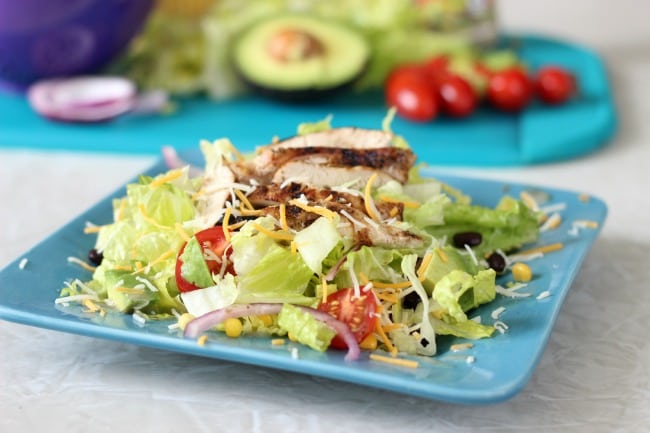 grilled chicken salad on a blue plate