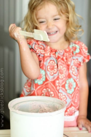 little girl eating ice cream from the ice cream machine